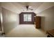 Spacious bedroom with neutral carpet, ceiling fan, and ample natural light from the window at 3341 Deer Hollow Sw Trl, Conyers, GA 30094
