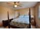 Comfortable bedroom featuring a four poster bed and a ceiling fan with lighting at 3341 Deer Hollow Sw Trl, Conyers, GA 30094