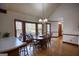Sunlit breakfast nook with large windows, hardwood floors, and a modern light fixture at 3341 Deer Hollow Sw Trl, Conyers, GA 30094
