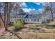Charming two-story home with a lush green lawn, mature trees, and a welcoming front porch at 3341 Deer Hollow Sw Trl, Conyers, GA 30094