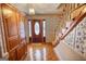 Inviting foyer with hardwood floors, decorative wallpaper, and elegant staircase at 3341 Deer Hollow Sw Trl, Conyers, GA 30094