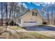 Spacious two-car garage with an attached side entry and lush tree coverage at 3341 Deer Hollow Sw Trl, Conyers, GA 30094