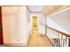 Upper hallway with view into other rooms of the house, carpeted flooring, and wood railing at 3341 Deer Hollow Sw Trl, Conyers, GA 30094