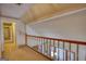 Upper hallway with wood railing overlooking the home's dining and living room below at 3341 Deer Hollow Sw Trl, Conyers, GA 30094