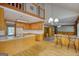Spacious open kitchen with wood cabinets, an island with bar seating, and hardwood floors at 3341 Deer Hollow Sw Trl, Conyers, GA 30094