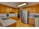 Well-equipped kitchen with stainless steel refrigerator, hardwood floors, and white countertops at 3341 Deer Hollow Sw Trl, Conyers, GA 30094