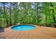 Enjoy the outdoors on the deck with this lovely above ground pool surrounded by mature trees at 3341 Deer Hollow Sw Trl, Conyers, GA 30094