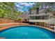 Gorgeous swimming pool and back exterior featuring multi-tiered deck and screened-in porch at 3341 Deer Hollow Sw Trl, Conyers, GA 30094