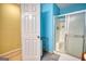 Shower stall with sliding glass doors and white fixtures, adjacent to a white door at 3341 Deer Hollow Sw Trl, Conyers, GA 30094