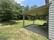 Spacious covered back porch with outdoor fan overlooking a large grassy backyard at 165 Jodi Pl, Locust Grove, GA 30248