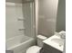 Bathroom with shower-tub combination, single sink vanity with stone countertop and gray cabinets at 165 Jodi Pl, Locust Grove, GA 30248
