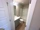 Bathroom featuring a single sink vanity with gray cabinets and a shower-tub combination at 165 Jodi Pl, Locust Grove, GA 30248