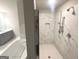 Bathroom features a separate tile shower, soaking tub, and double sink vanity with gray cabinets at 165 Jodi Pl, Locust Grove, GA 30248
