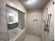 Bathroom featuring tile shower, large soaking tub and double sink vanity with gray cabinets at 165 Jodi Pl, Locust Grove, GA 30248