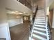 Grand foyer features coffered ceilings, wainscoting, staircase with metal spindles, and hardwood floors for a welcoming ambiance at 165 Jodi Pl, Locust Grove, GA 30248