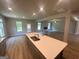 Kitchen featuring stainless appliances, an island with a sink, and an open design leading to the living areas at 165 Jodi Pl, Locust Grove, GA 30248