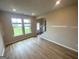 Bright living room offering natural light, a view of the staircase, and modern flooring for a welcoming atmosphere at 165 Jodi Pl, Locust Grove, GA 30248