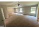 Expansive main bedroom boasts tray ceilings, ceiling fan, carpet flooring, and natural light for a serene retreat at 165 Jodi Pl, Locust Grove, GA 30248