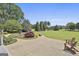 Spacious backyard with manicured landscaping and relaxing wood chairs at 780 Birkdale Dr, Fayetteville, GA 30215