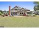 Expansive backyard with a stone patio, manicured lawn, and established trees at 780 Birkdale Dr, Fayetteville, GA 30215