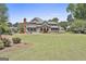 Expansive lawn and mature trees create a private and serene outdoor space, perfect for enjoying nature at 780 Birkdale Dr, Fayetteville, GA 30215