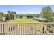 Scenic backyard view from the deck overlooking the lush lawn and a lake in the distance at 780 Birkdale Dr, Fayetteville, GA 30215