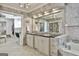 Luxurious bathroom with marble tile, dual vanity sinks, and access to the closet at 780 Birkdale Dr, Fayetteville, GA 30215
