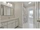 Bright bathroom featuring tile floors, a spacious vanity, and a colorful shower curtain at 780 Birkdale Dr, Fayetteville, GA 30215
