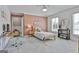 Neutral-toned bedroom with natural light features wood floors and a study desk, creating a cozy and functional space at 780 Birkdale Dr, Fayetteville, GA 30215