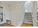 A welcoming entryway with custom built-in bench seating and storage, adjacent to a carpeted staircase at 780 Birkdale Dr, Fayetteville, GA 30215