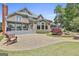 Rear exterior with patio, balcony, landscaped yard, and architectural details at 780 Birkdale Dr, Fayetteville, GA 30215