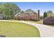 Stunning brick home with well-manicured lawn and a circular driveway offering beautiful curb appeal at 780 Birkdale Dr, Fayetteville, GA 30215