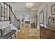 Inviting foyer with hardwood floors, staircase, elegant chandelier, and views into other living spaces at 780 Birkdale Dr, Fayetteville, GA 30215