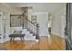 Welcoming foyer with hardwood floors, staircase with dark railings, and a bench for seating at 780 Birkdale Dr, Fayetteville, GA 30215