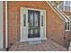 Elegant front door with glass panels and sidelights, complemented by a brick entryway and a welcome mat at 780 Birkdale Dr, Fayetteville, GA 30215