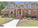 Inviting brick home with a covered front porch, showcasing manicured landscaping and a welcoming entryway at 780 Birkdale Dr, Fayetteville, GA 30215