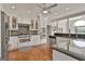 Bright kitchen showcasing stainless steel appliances, black countertops, and an island with bar seating at 780 Birkdale Dr, Fayetteville, GA 30215