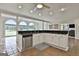 Open kitchen and living space with large arch windows, granite countertops, and recessed lighting at 780 Birkdale Dr, Fayetteville, GA 30215