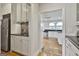 Modern kitchen with stainless fridge, granite counters, and ample cabinets, conveniently located near living areas at 780 Birkdale Dr, Fayetteville, GA 30215