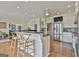 Open-concept kitchen with island seating, stainless steel appliances, and seamless flow to living areas at 780 Birkdale Dr, Fayetteville, GA 30215