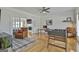 Bright living room featuring hardwood floors, a foosball table, and a comfortable leather armchair at 780 Birkdale Dr, Fayetteville, GA 30215