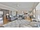 Bright living room with large gray sectional sofa, patterned rug, and hardwood flooring throughout the house at 780 Birkdale Dr, Fayetteville, GA 30215