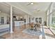 Bright, open living space with tile flooring, dining table, and an open kitchen area with a breakfast bar at 780 Birkdale Dr, Fayetteville, GA 30215