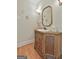 Charming powder room with wood vanity, elegant mirror, and decorative wall accents at 780 Birkdale Dr, Fayetteville, GA 30215