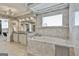 Elegant bathroom with soaking tub, dual vanities, a large window, marble tiling, and a separate shower at 780 Birkdale Dr, Fayetteville, GA 30215