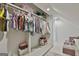 Spacious walk-in closet provides ample storage with clothing racks and shelves, complete with tile floors and bonus sofa at 780 Birkdale Dr, Fayetteville, GA 30215