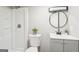 Modern bathroom featuring a walk-in shower, sleek vanity, and stylish round mirror at 1120 Starline Dr, Smyrna, GA 30080