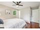 Cozy bedroom featuring hardwood floors, ceiling fan, and natural light at 1120 Starline Dr, Smyrna, GA 30080