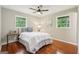 Comfortable bedroom with hardwood floors, ceiling fan, and natural light at 1120 Starline Dr, Smyrna, GA 30080