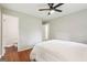 Inviting bedroom featuring hardwood floors, ceiling fan, and access to bathroom at 1120 Starline Dr, Smyrna, GA 30080